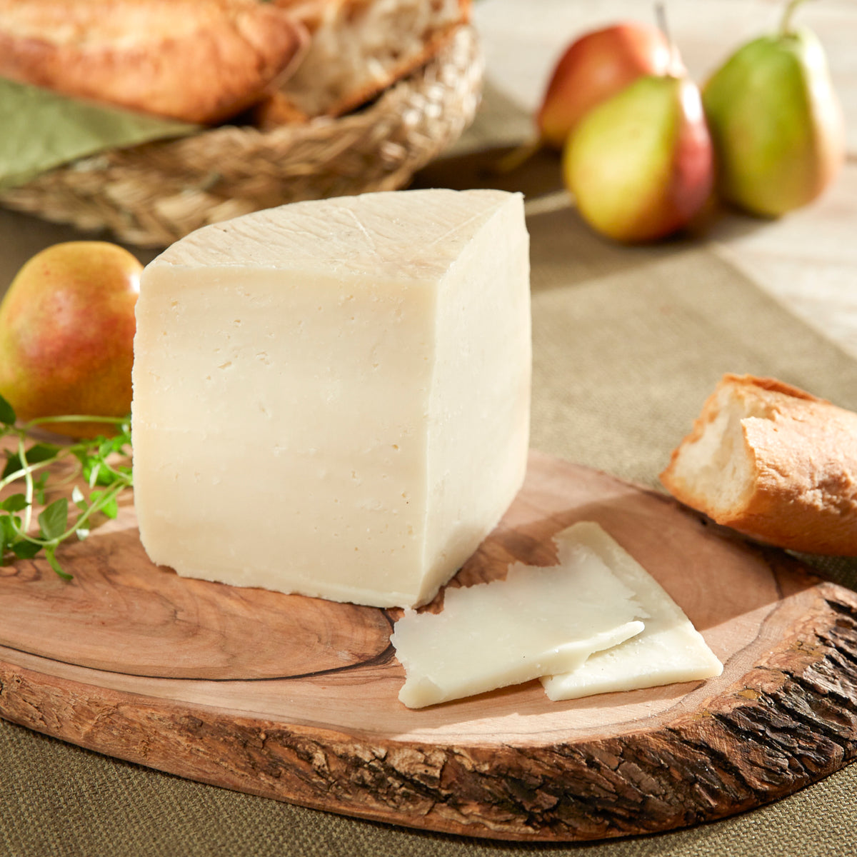 Photo of a wedge of Queso Payoyo cheese on a rustic wooden board