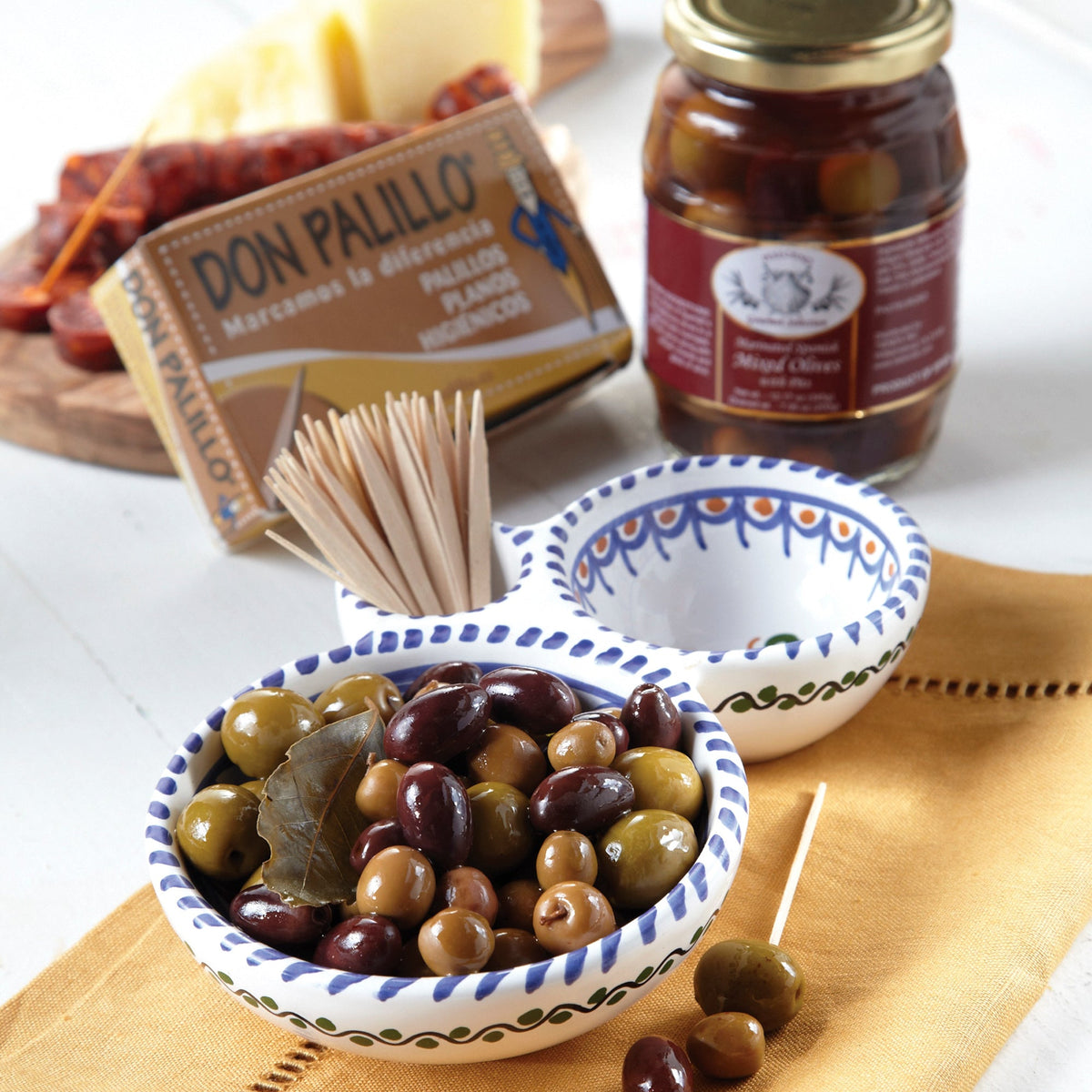 Photo of an olive serving dish with mixed olives and flat Spanish toothpicks