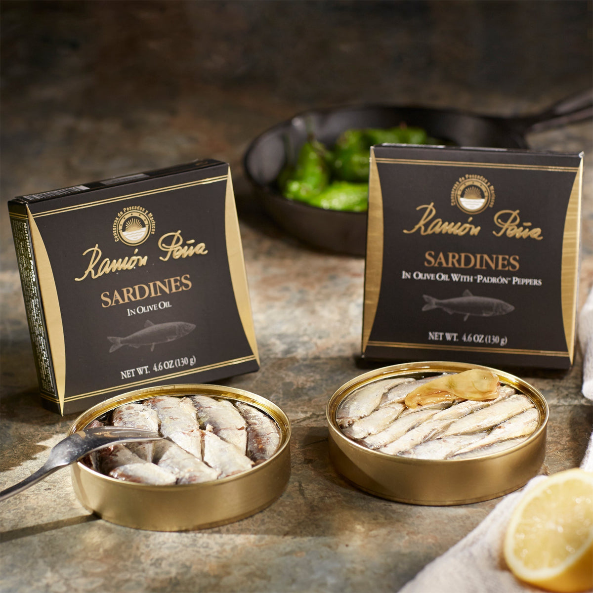 Photo of open tins of two types of sardines by Ramon Pena
