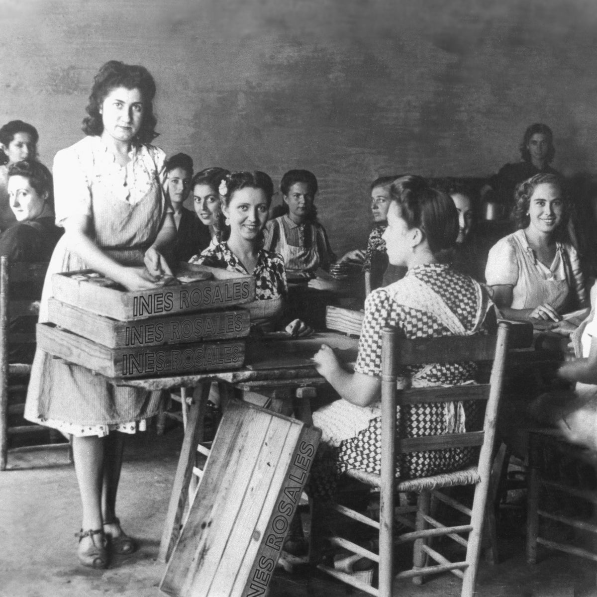 Historic black and white image of Ines Rosales workers wrapping tortas cookies