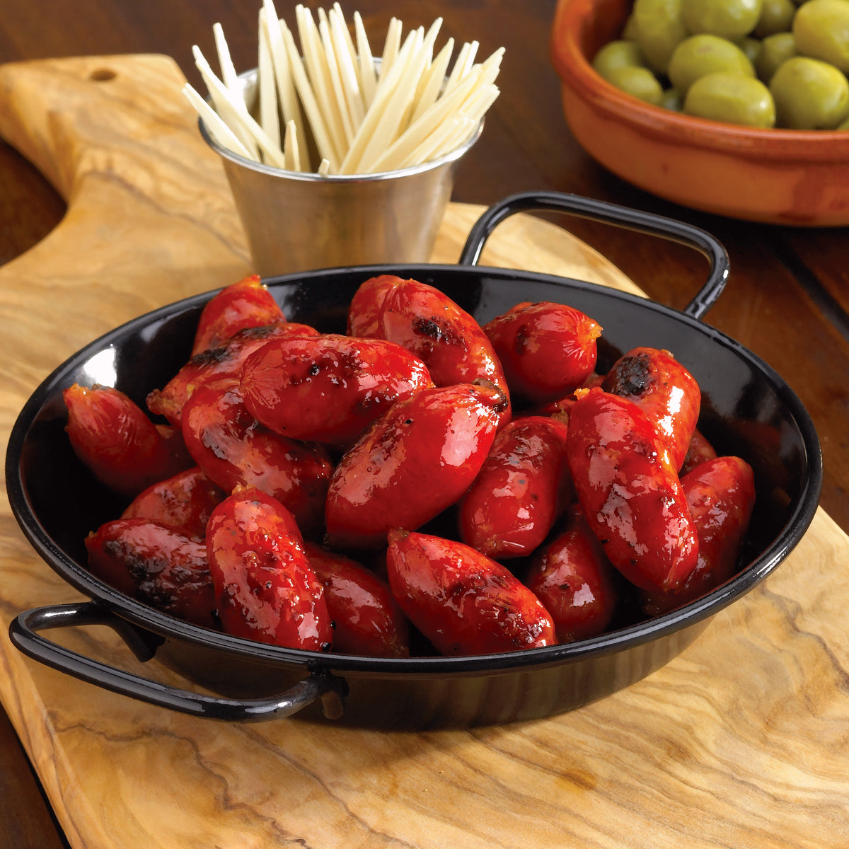 Photo of Mini Cooking Chorizo Links in a small enamel paella pan