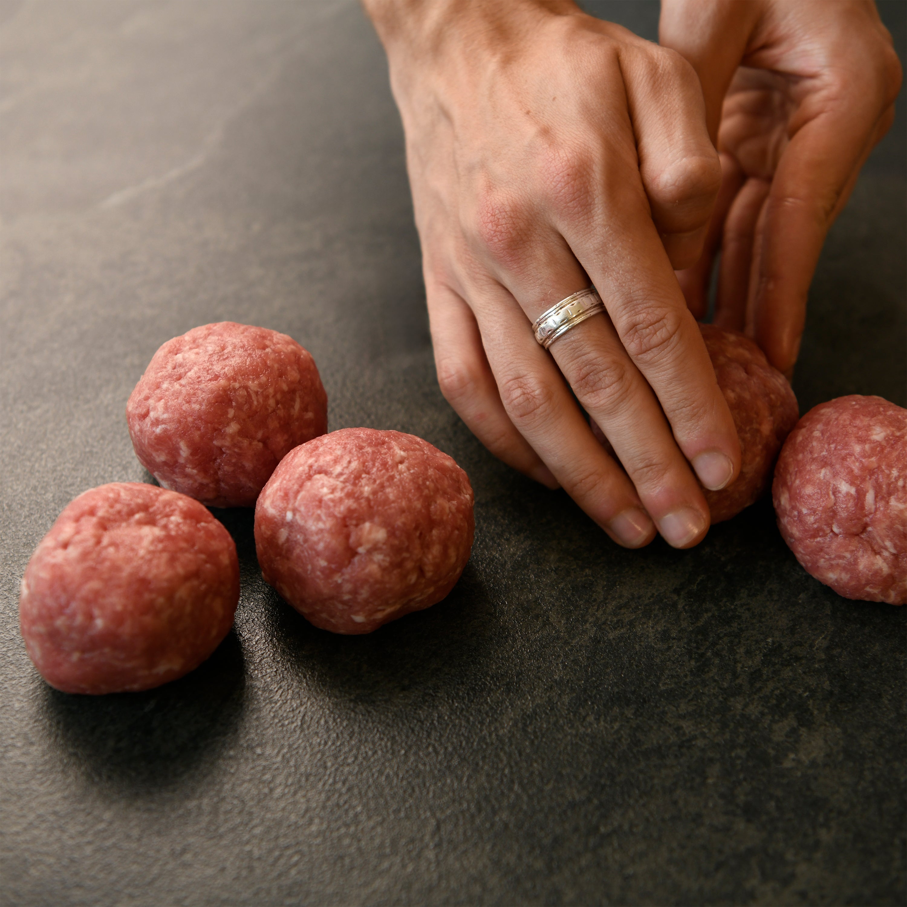Photo of hands forming patties with Texas Iberico Ground Iberico Pork